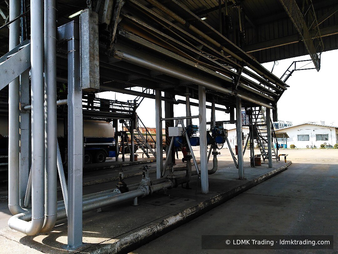 Overhead pipe rack and loading gantry above a road tanker at a SCDP depot.